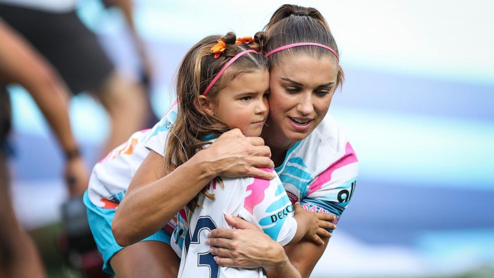 PHOTO: San Diego Wave FC forward Alex Morgan hugs her daughter, Charlie Carrasco, during a pregame ceremony honoring Morgan before her last match, Sept. 8, 2024, in San Diego.