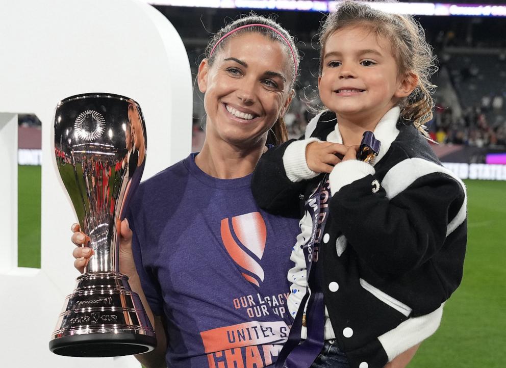 PHOTO: Alex Morgan of the U.S. poses for a photo with her daughter Charlie Elena Carrasco after defeating Brazil during the 2024 Concacaf W Gold Cup final, Mar. 10, 2024, in San Diego, Calif.