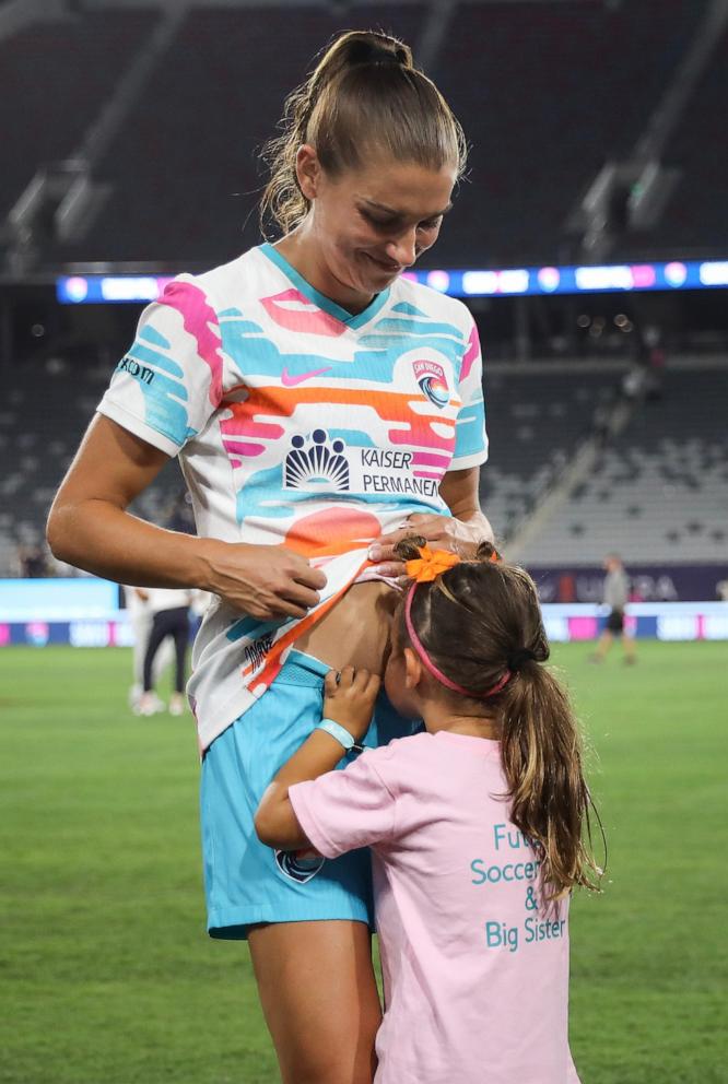 PHOTO: Alex Morgan of San Diego Wave FC with her daughter, Charlie, after the last match of her career Sept. 8, 2024, in San Diego.