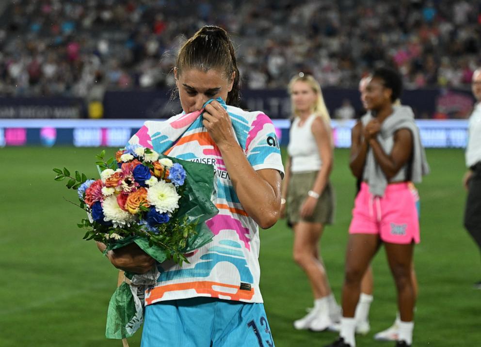 PHOTO: San Diego Wave FC forward Alex Morgan wipes her eyes after being sprayed with champagne after playing in the final match of her career, Sept. 8, 2024, in San Diego.