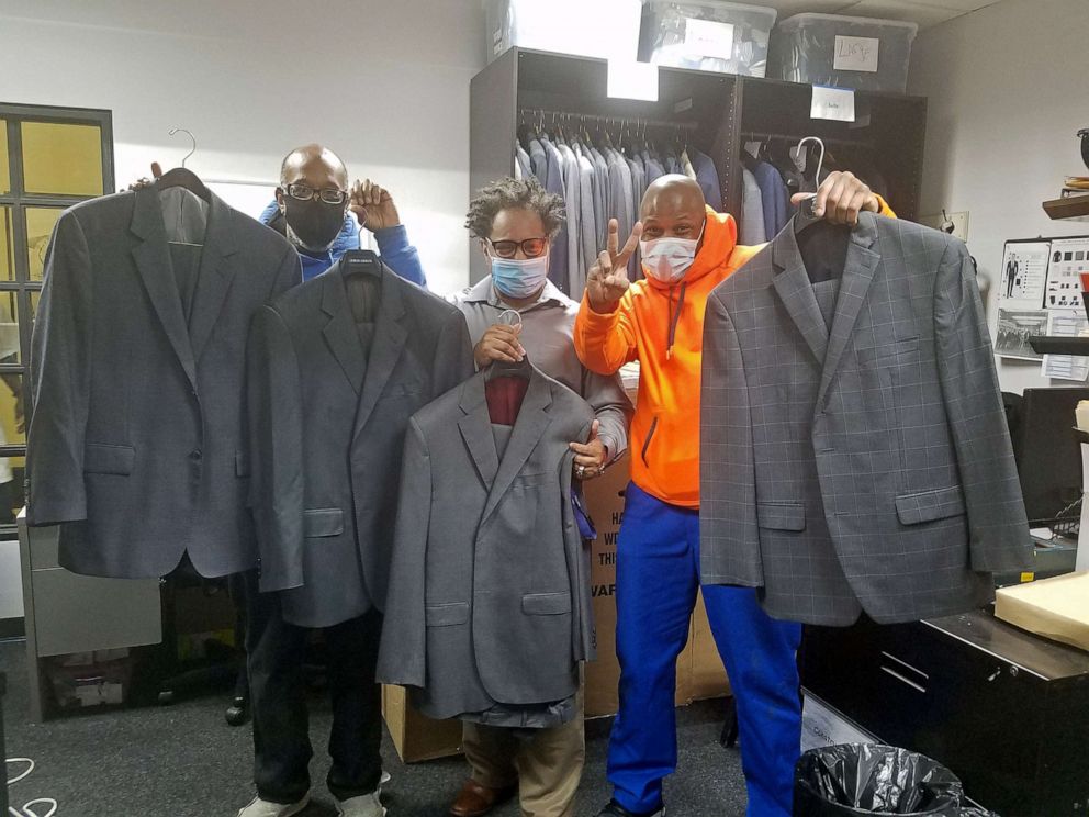 PHOTO: Trainees from The Doe Fund’s “Ready, Willing & Able” program, (r-l) Michael Smith, Joseph Calhoun and George Thomas, receive donated wardrobe items worn by the late Alex Trebek.
