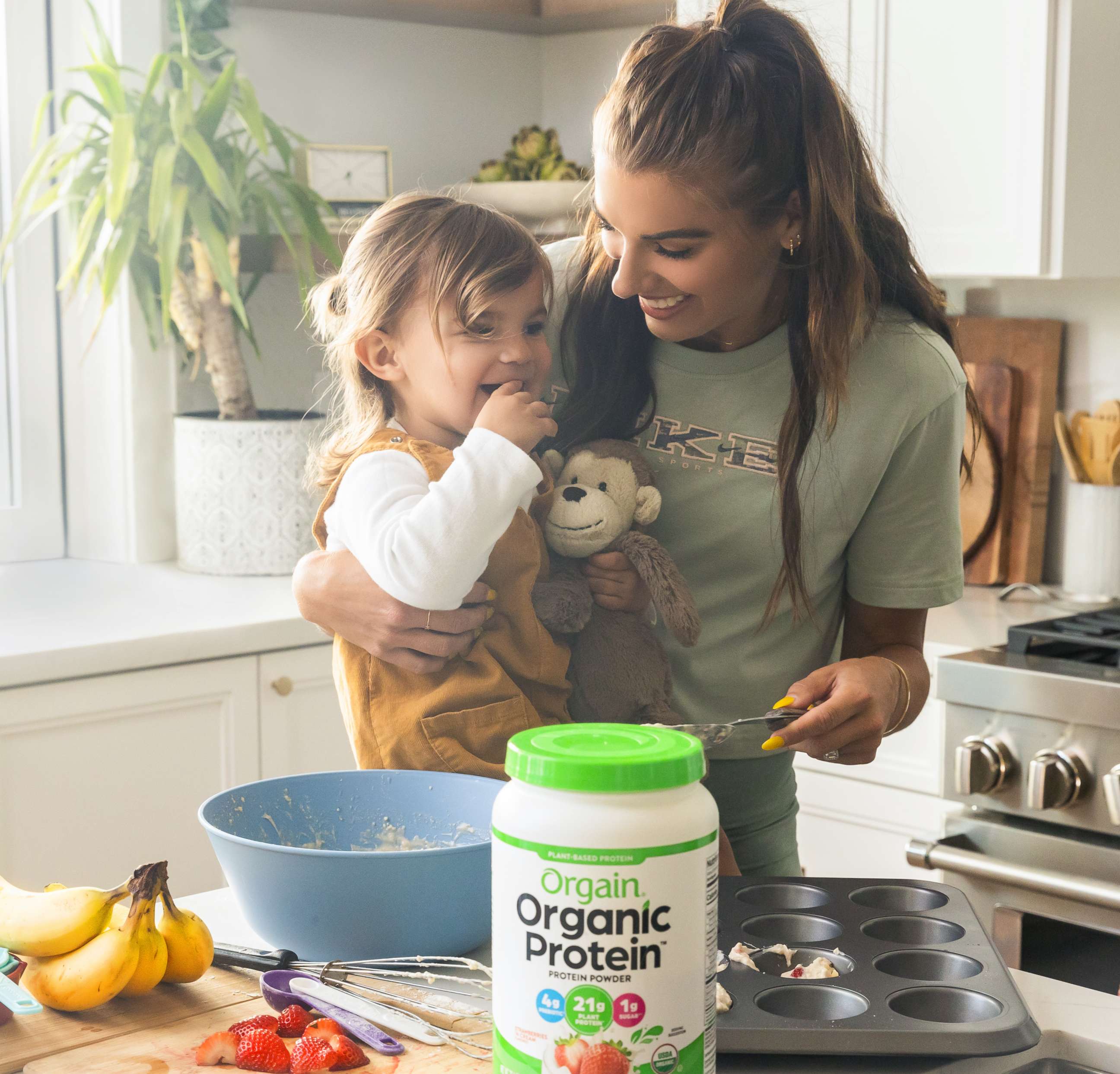 PHOTO: Alex Morgan with her daughter Charlie baking protein snacks in the kitchen.