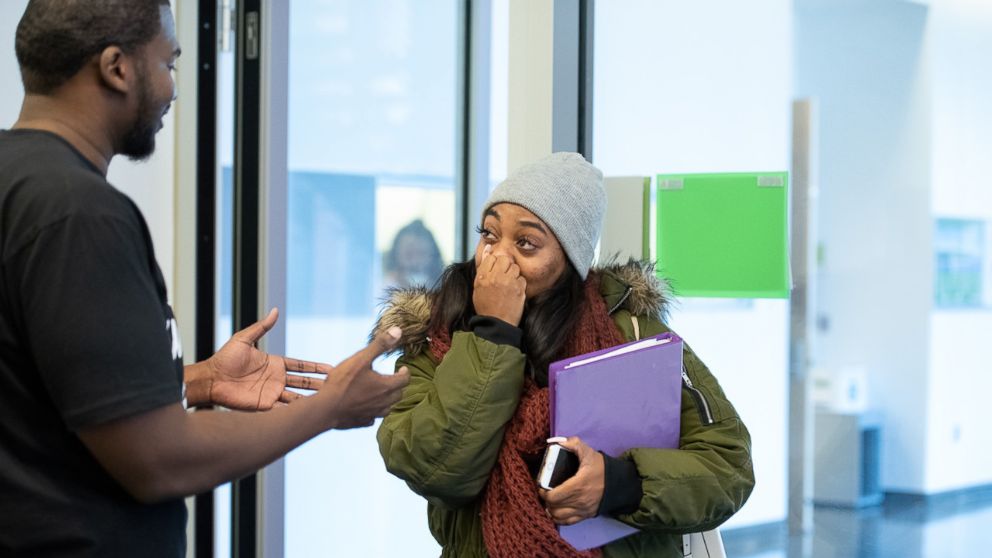 PHOTO: Howard University senior Mya Thompson learns from Rev. Marc Lavarin that Alfred Street Baptist Church is paying her student debt.