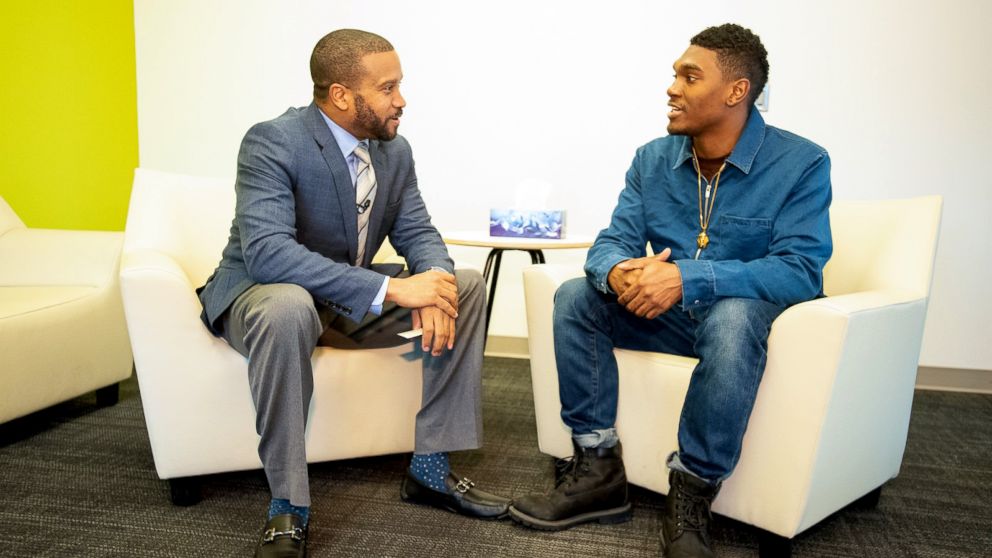 PHOTO: Rev. Dr. Howard-John Wesley, pastor of Alfred Street Baptist Church, tells a Howard University senior that his debt is paid off.