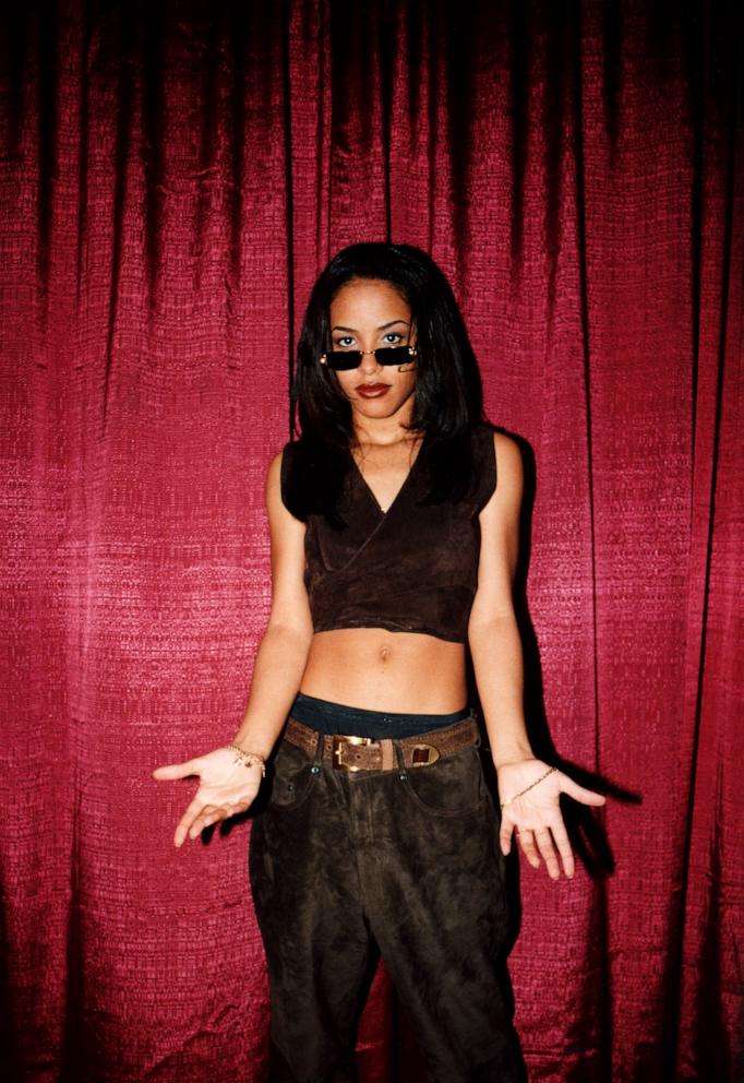 PHOTO: Aaliyah poses for photos backstage after her performance during the Big Beat/Atlantic Records showcase at the Impact Music Convention in Miami, April 1997. 