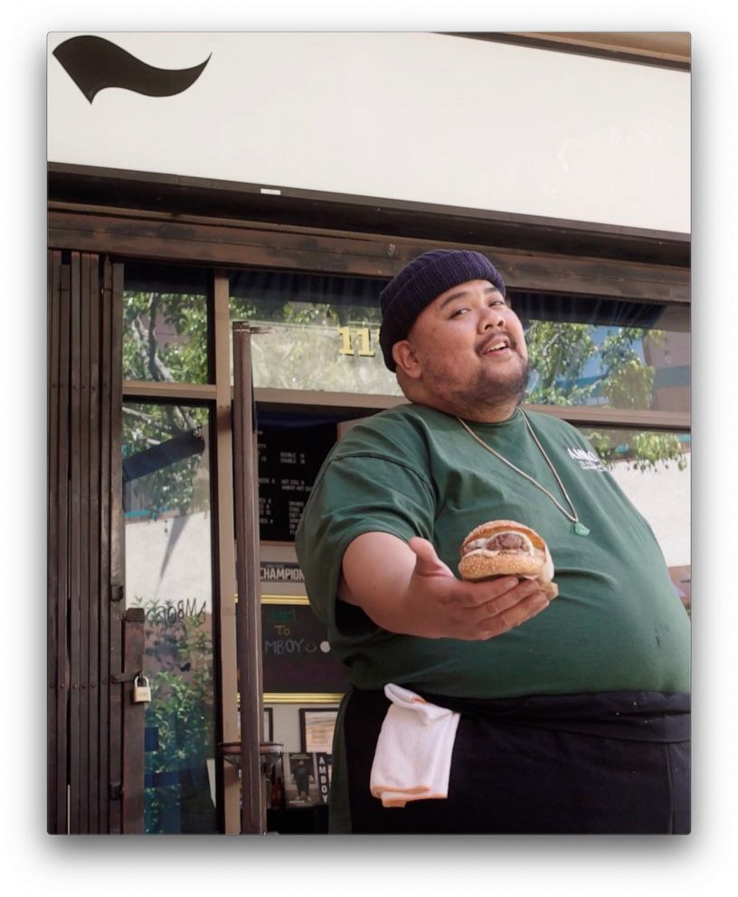 PHOTO: Chef Alvin Cailan holding a signature burger from his menu.