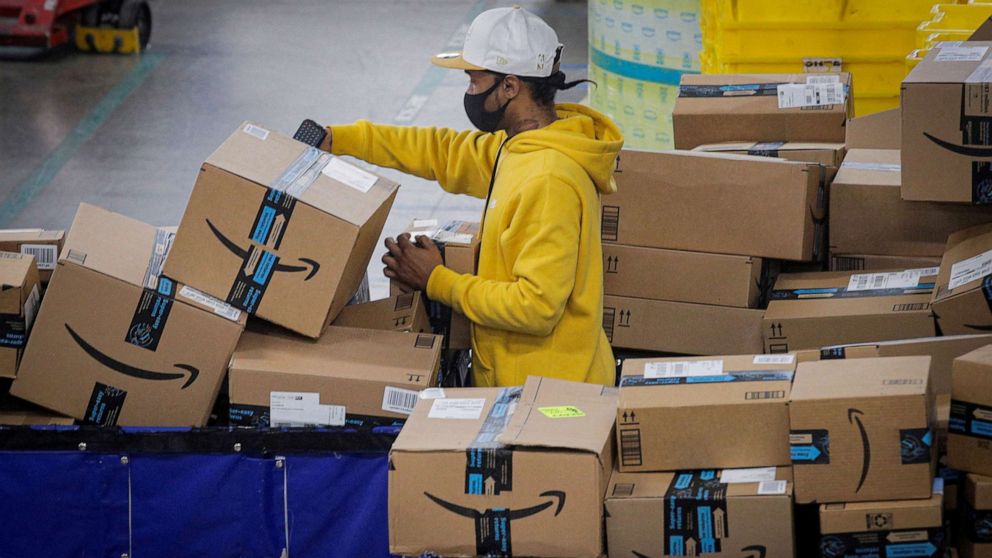 An employee scans packages at an Amazon distribution center in Staten Island, New York, Nov. 25, 2020.