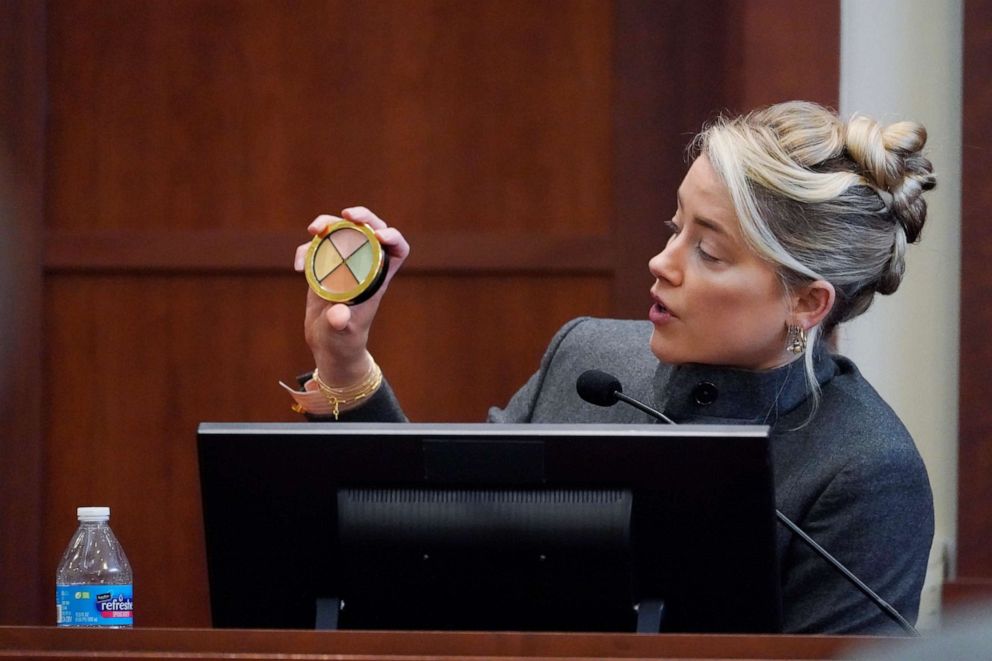 PHOTO: Actor Amber Heard testifies and displays a makeup kit in the courtroom at the Fairfax County Circuit Courthouse in Fairfax, Va., Monday, May 16, 2022.