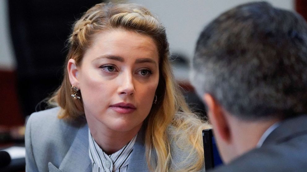 PHOTO: Actor Amber Heard talks with her legal team in the courtroom during ex-husband Johnny Depp's defamation case against her at the Fairfax County Circuit Courthouse in Fairfax, Va., May 27, 2022.