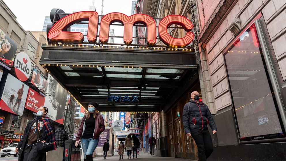 PHOTO: People walk outside the AMC Empire 25 movie theater in Times Square as the city continues the re-opening efforts following restrictions imposed to slow the spread of coronavirus, Dec. 23, 2020, New York.