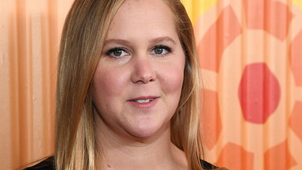 VIDEO: Amy Schumer and Chris Fischer talk to us live from their bed about ‘Expecting Amy’