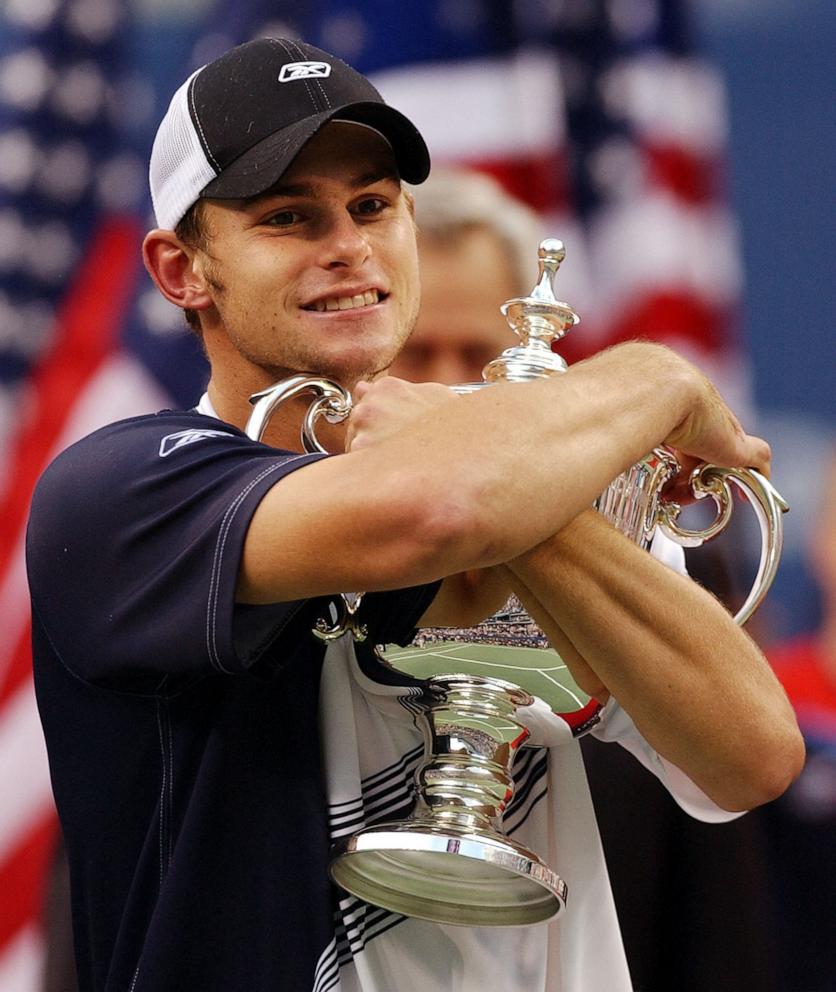 PHOTO: In this Sept. 7, 2023 file photo, Andy Roddick hugs the trophy after defeating Juan Carlos Ferrero in the men's finals at the U.S. Open in Flushing Meadows, N.Y. 