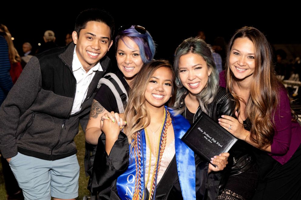 PHOTO: Anna Sarol walked for the first time in years across her graduation stage with the help of her siblings, pictured here.