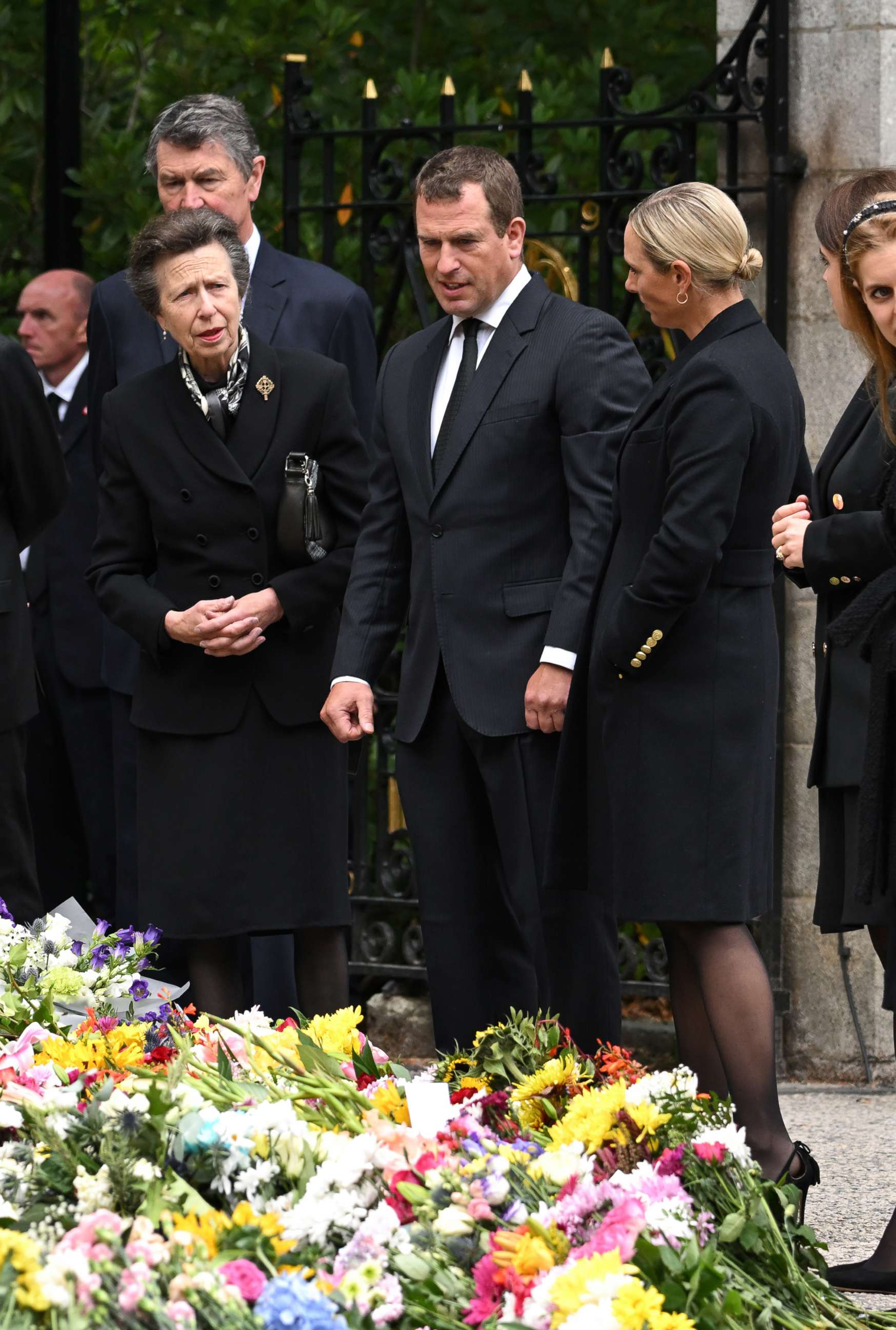 PHOTO: Timothy Laurence, Anne, Princess Royal, Peter Phillips and Zara Phillips view the flowers left by mourners outside Balmoral Castle, Sept. 10, 2022, in Aberdeen, Scotland. 