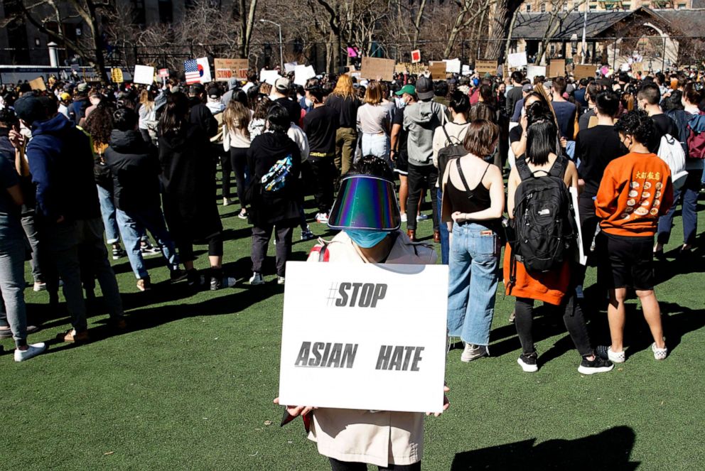 PHOTO: A woman holds a placard during a rally against Asian hate at Columbus Park in Chinatown on March 21, 2021, in New York.
