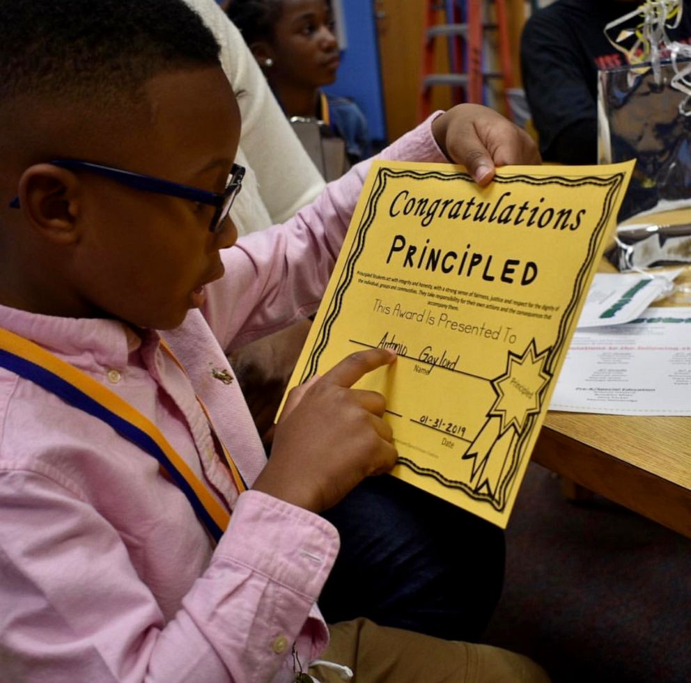 PHOTO: Antonio, 6, with a certificate awarded to him for his integrity and honesty at school.