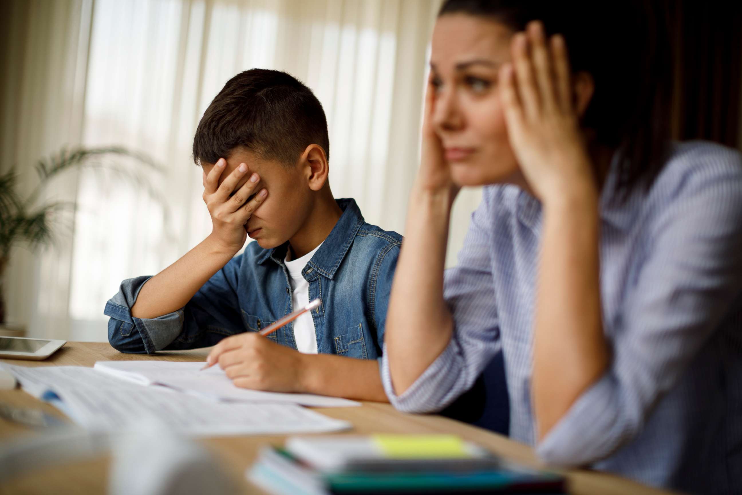 PHOTO: An undated stock photo depicts a stressed mother and son sitting at a table.