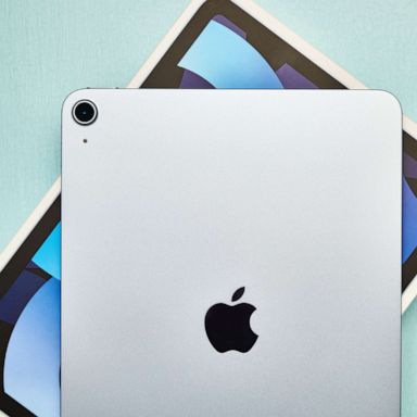 PHOTO: A studio shot of a brand new Apple iPad Air 4 in sky blue with its packaging on a pale blue surface.