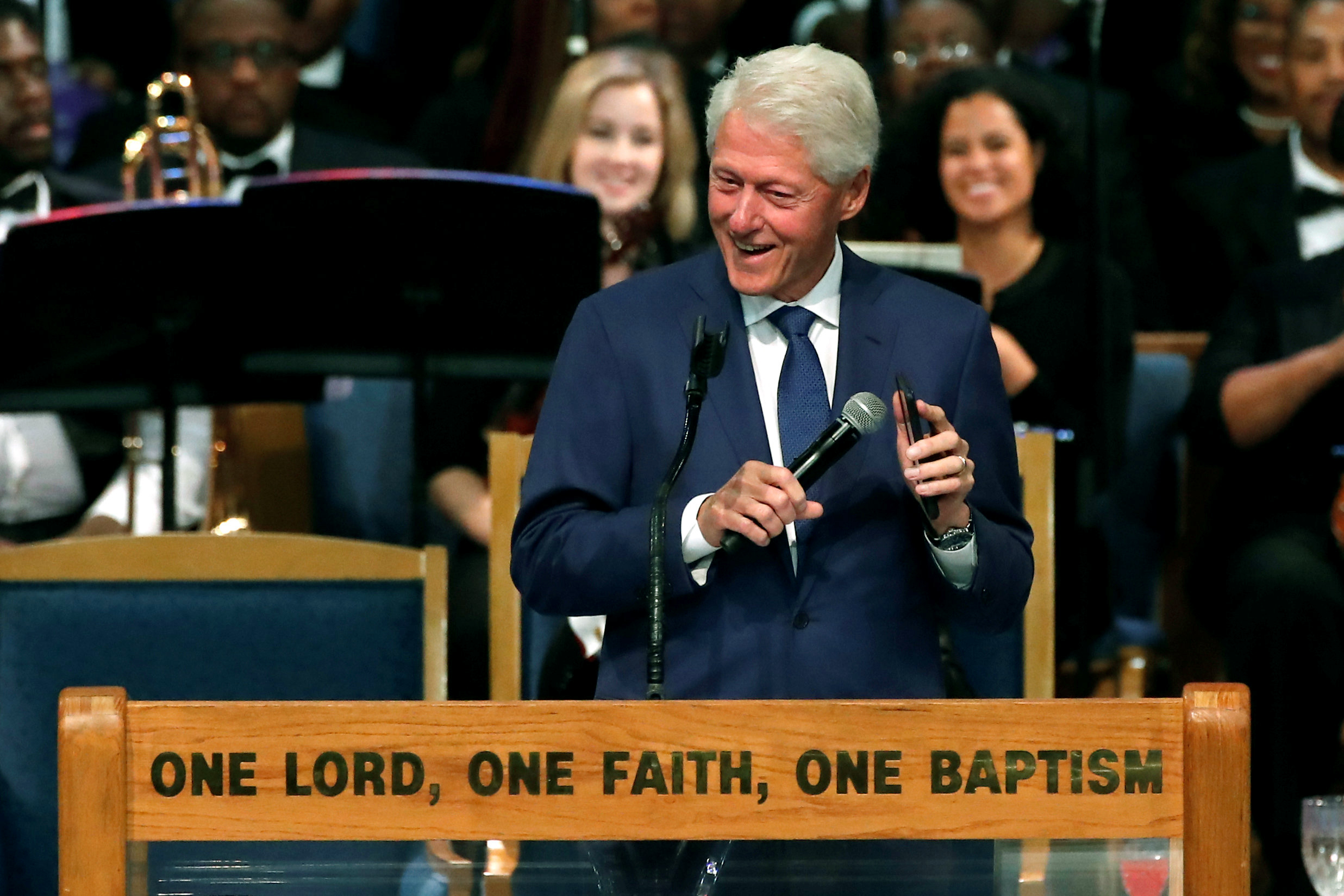 PHOTO: Former President Bill Clinton plays Aretha Franklin music on his mobile phone while speaking at the funeral service for the late singer at the Greater Grace Temple in Detroit, Aug. 31, 2018.