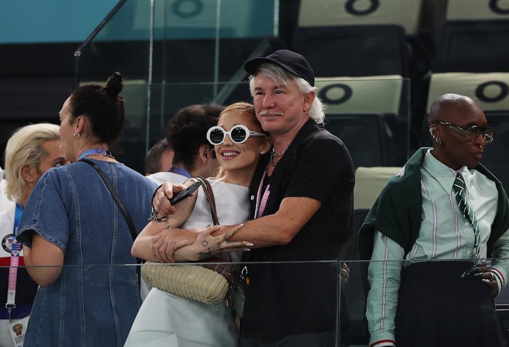 PHOTO: Ariana Grande greets Baz Luhrmann as they attend the Artistic Gymnastics Women's Qualification on day two of the Olympic Games Paris 2024 at Bercy Arena on July 28, 2024 in Paris.