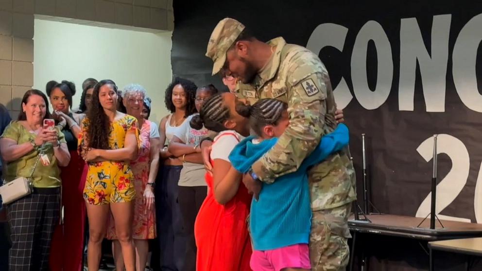 PHOTO: Chris Fulton surprised his two daughters at their school with his return after being deployed to the Middle East for almost a year.