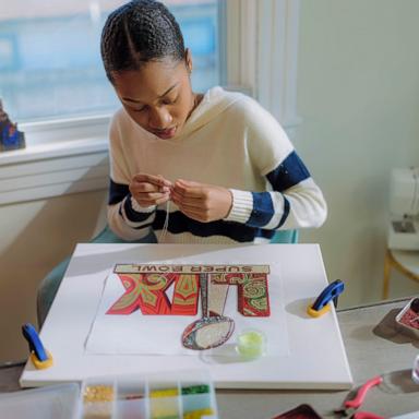 PHOTO: Tahj “Queen Tahj” Williams, a New Orleans artist and a member of the Golden Eagles of the Black Masking Indians, created the logo and theme art for Super Bowl LIX.