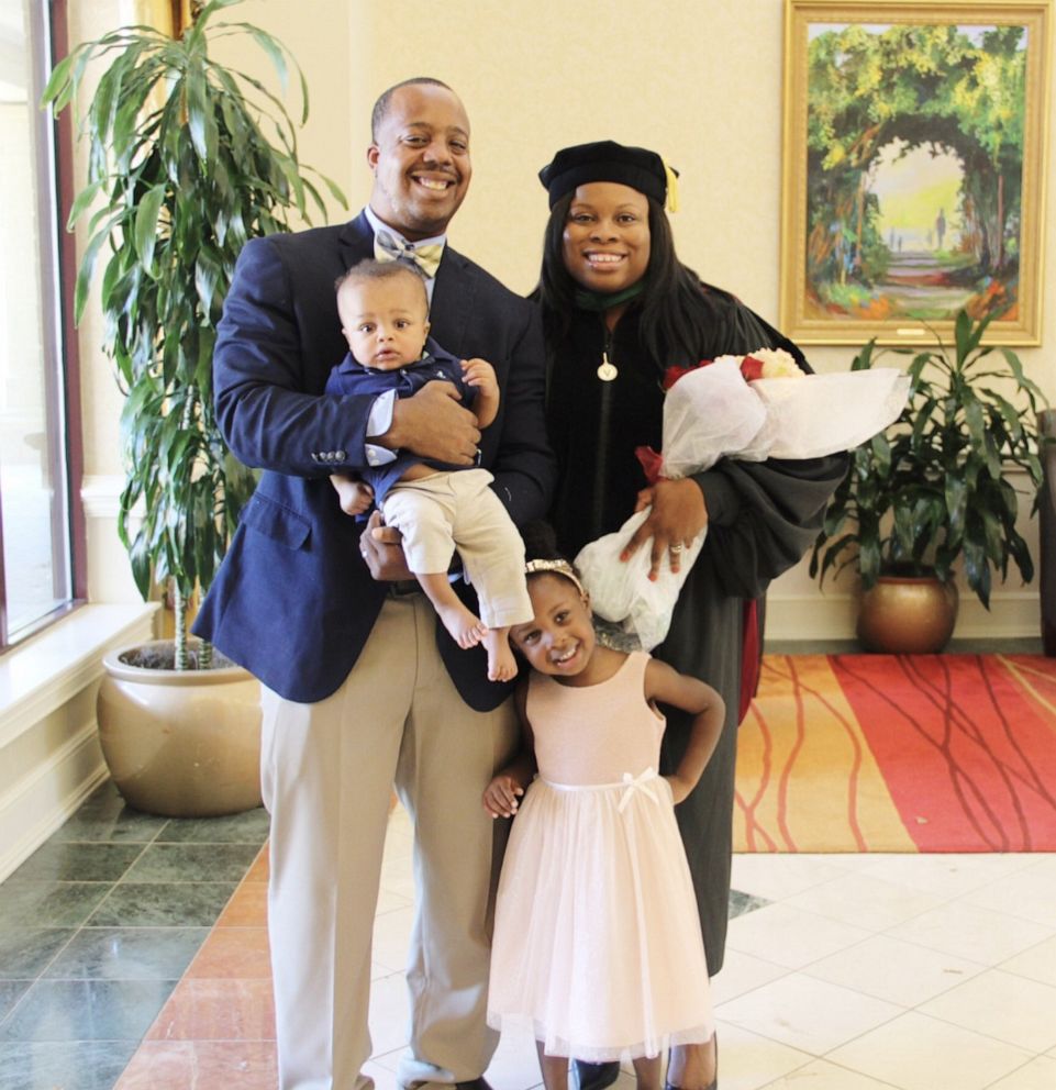 PHOTO: Dr. Ashley Denmark, a St. Louis-based doctor, smiles alongside her three children and husband, Anthony.