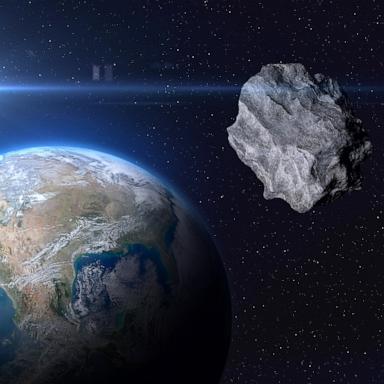 PHOTO: planet Earth and a big asteroid in space.