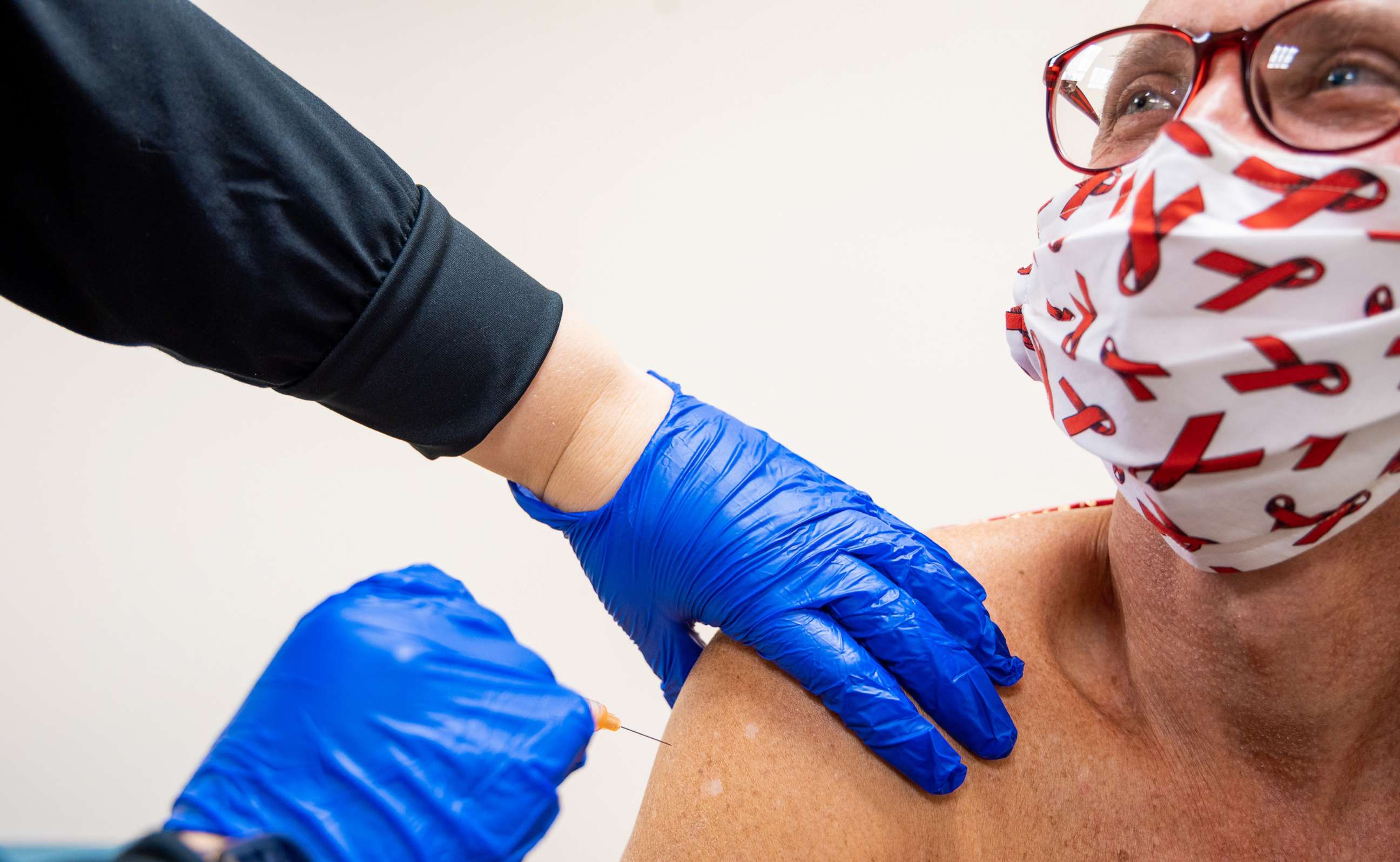 PHOTO: Marc Wagner, a researcher and activist, receives his second shot of an AstraZeneca COVID-19 vaccine during a clinical trial that began in late August 2020.