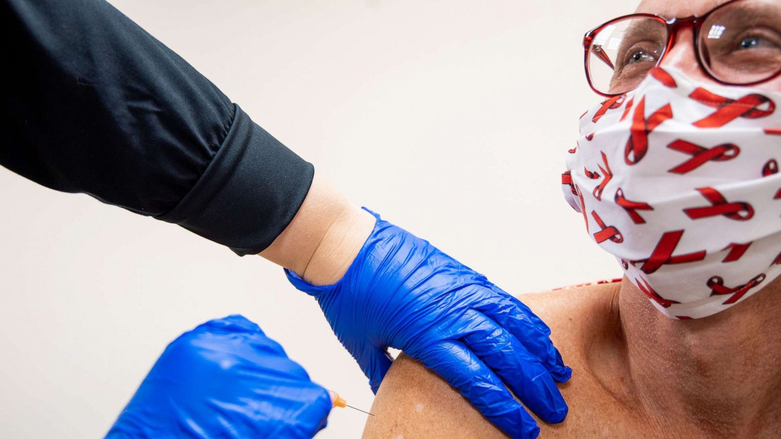 PHOTO: Marc Wagner, a researcher and activist, receives his second shot of an AstraZeneca COVID-19 vaccine during a clinical trial that began in late August 2020.