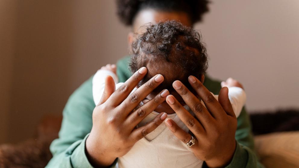 PHOTO: Stock photo of a parent holding their child.
