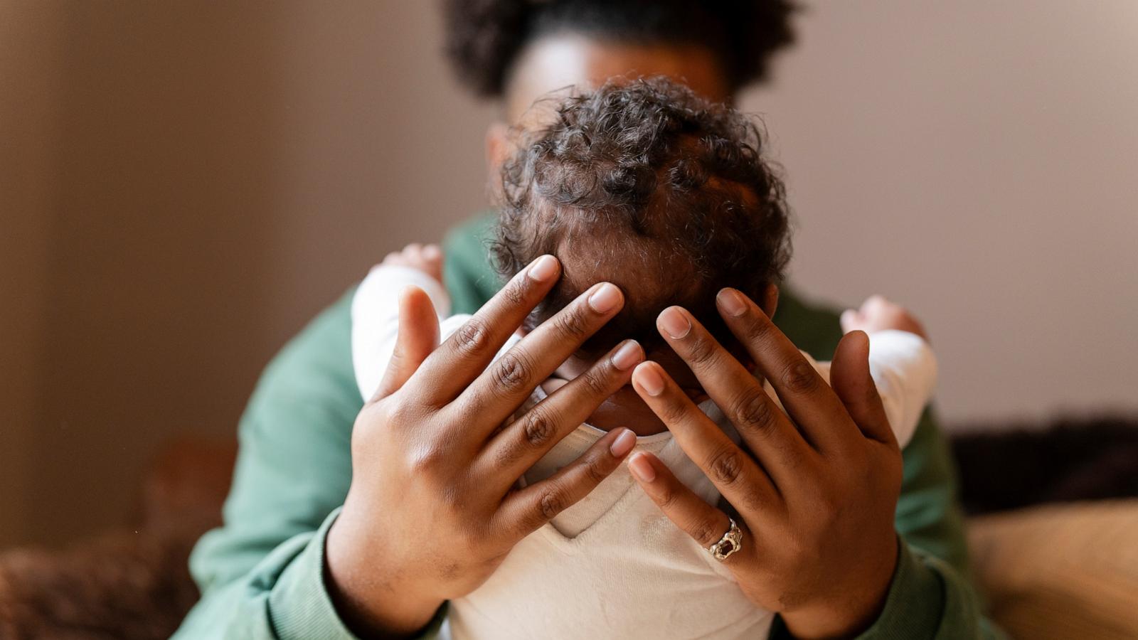 PHOTO: Stock photo of a parent holding their child.