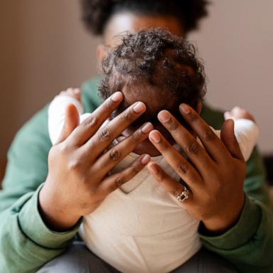 PHOTO: Stock photo of a parent holding their child.
