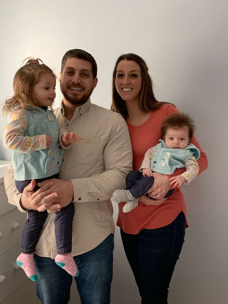 PHOTO: Anna being held by her mother, Lindsay Lattari, and pictured with father, Michael Lattari, and big sister, Charlotte Lattari.