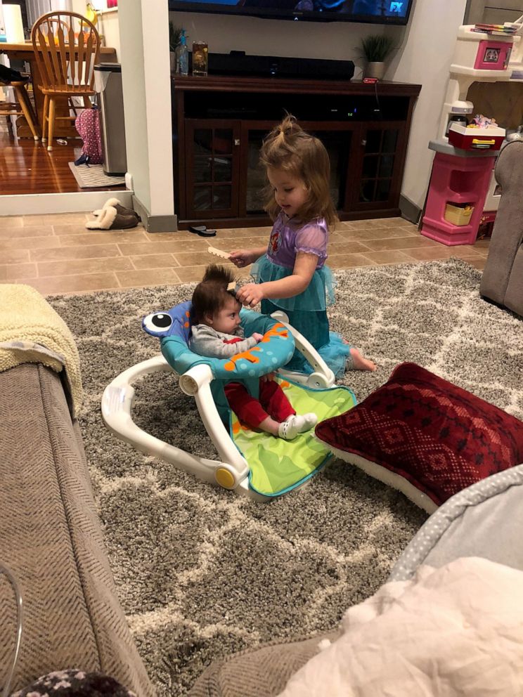 PHOTO: Big sister, Charlotte Lattari, gives Anna a pretend haircut.