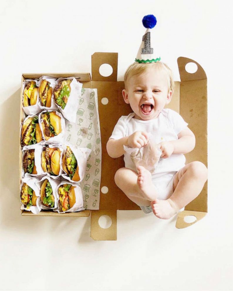 PHOTO: 12-month-old baby, Graham Morrison, smiles with a burger in hand for his twelfth milestone photo.