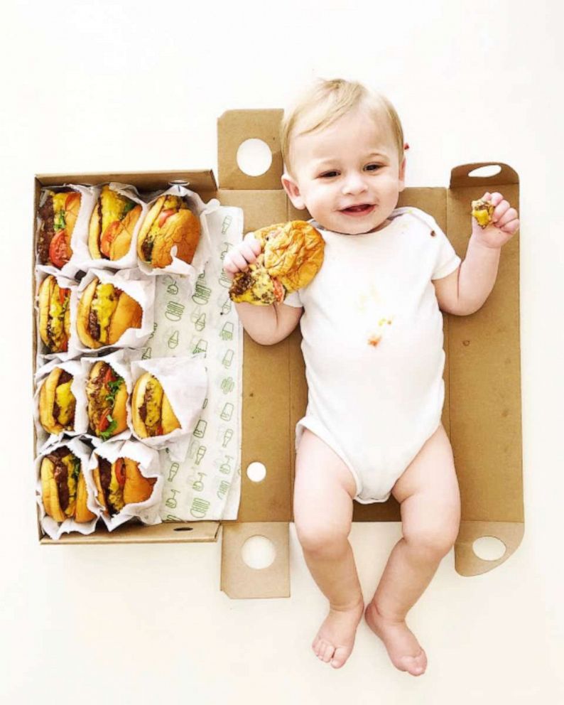 PHOTO: Graham Morrison holds a burger in his 11-month-old milestone picture.