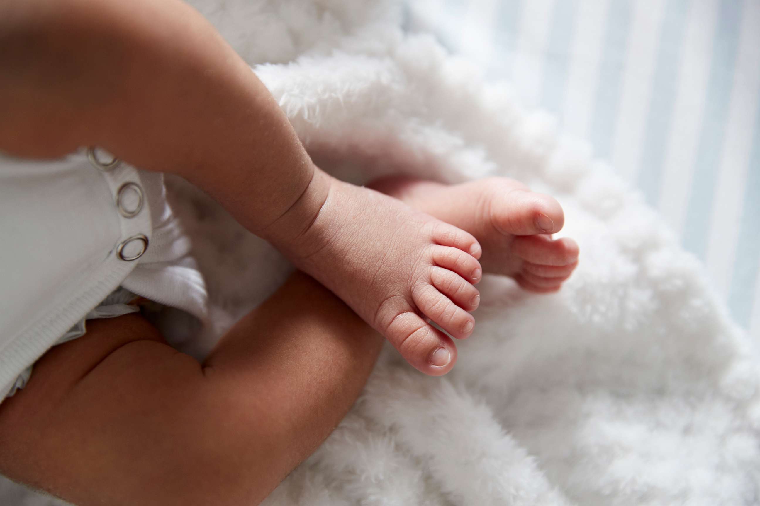 PHOTO: A closeup on a baby's feet in a crib.