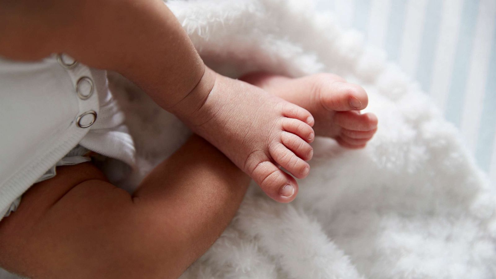 PHOTO: A closeup on a baby's feet in a crib.