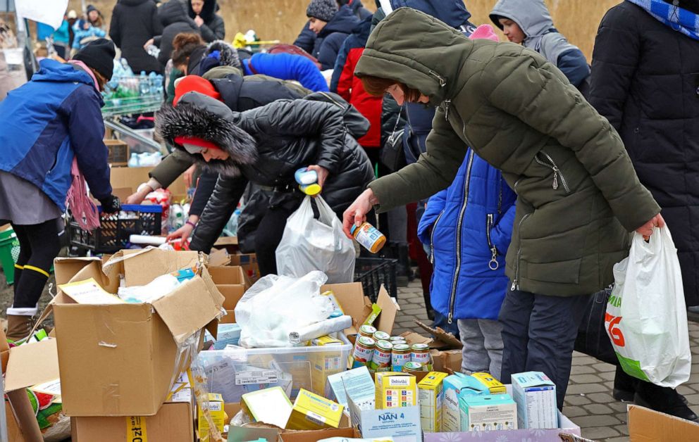 PHOTO:  People fleeing the Russian invasion receive donated baby food and supplies after crossing the border from Ukraine to Poland, at the border checkpoint in Medyka, Poland, March 6, 2022. 