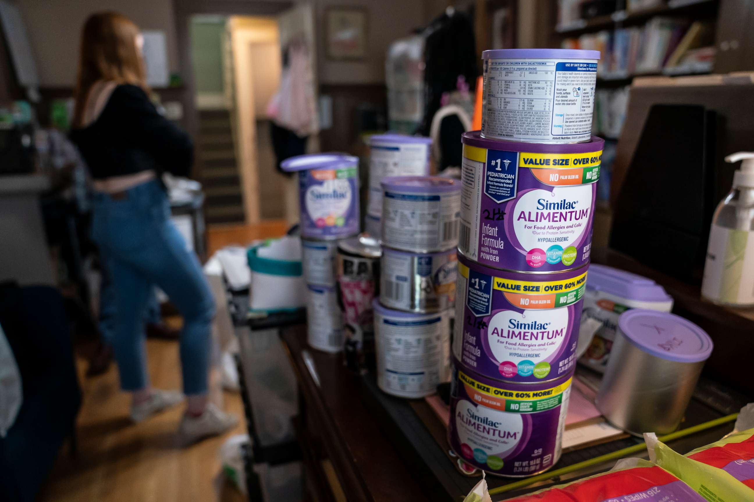 PHOTO: A program coordinator at Mother & Child Education Center throws away recalled Similac baby formula, May 12, 2022 in Portland, Oregon.