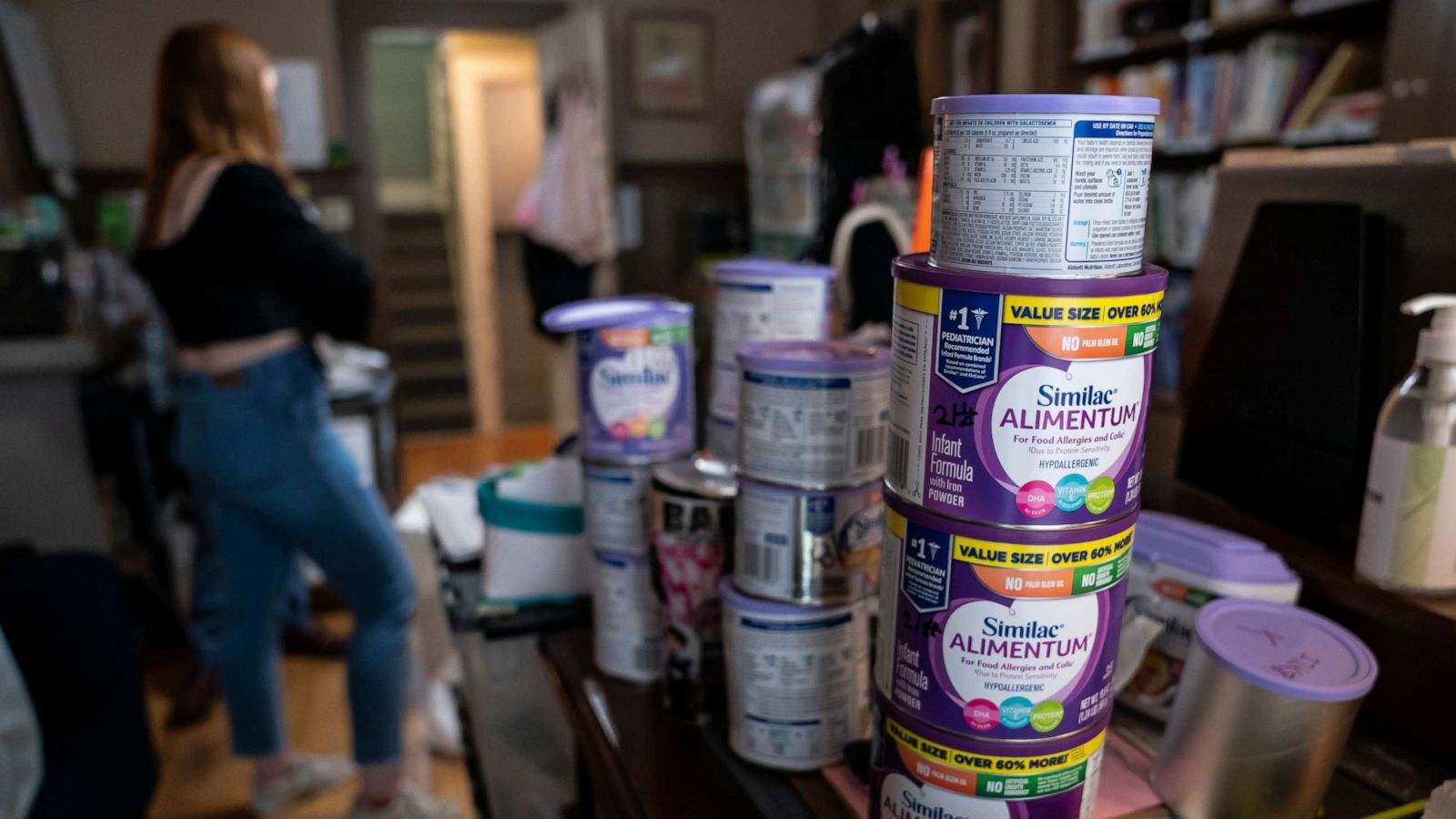 PHOTO: A program coordinator at Mother & Child Education Center throws away recalled Similac baby formula, May 12, 2022 in Portland, Oregon.