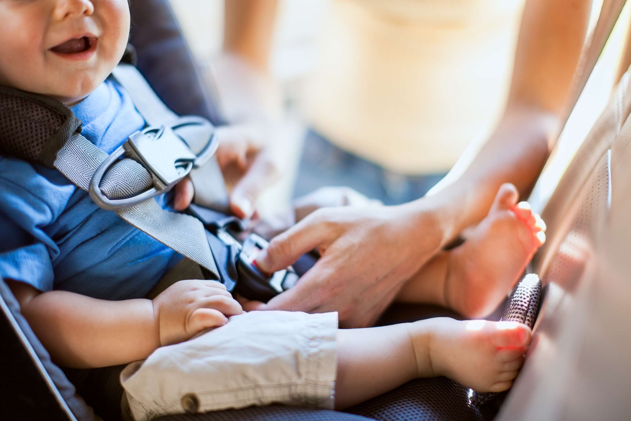 PHOTO:  In this undated stock photo, a mom buckles her infant son safely into a rear facing car seat as they get ready to drive somewhere in their vehicle.