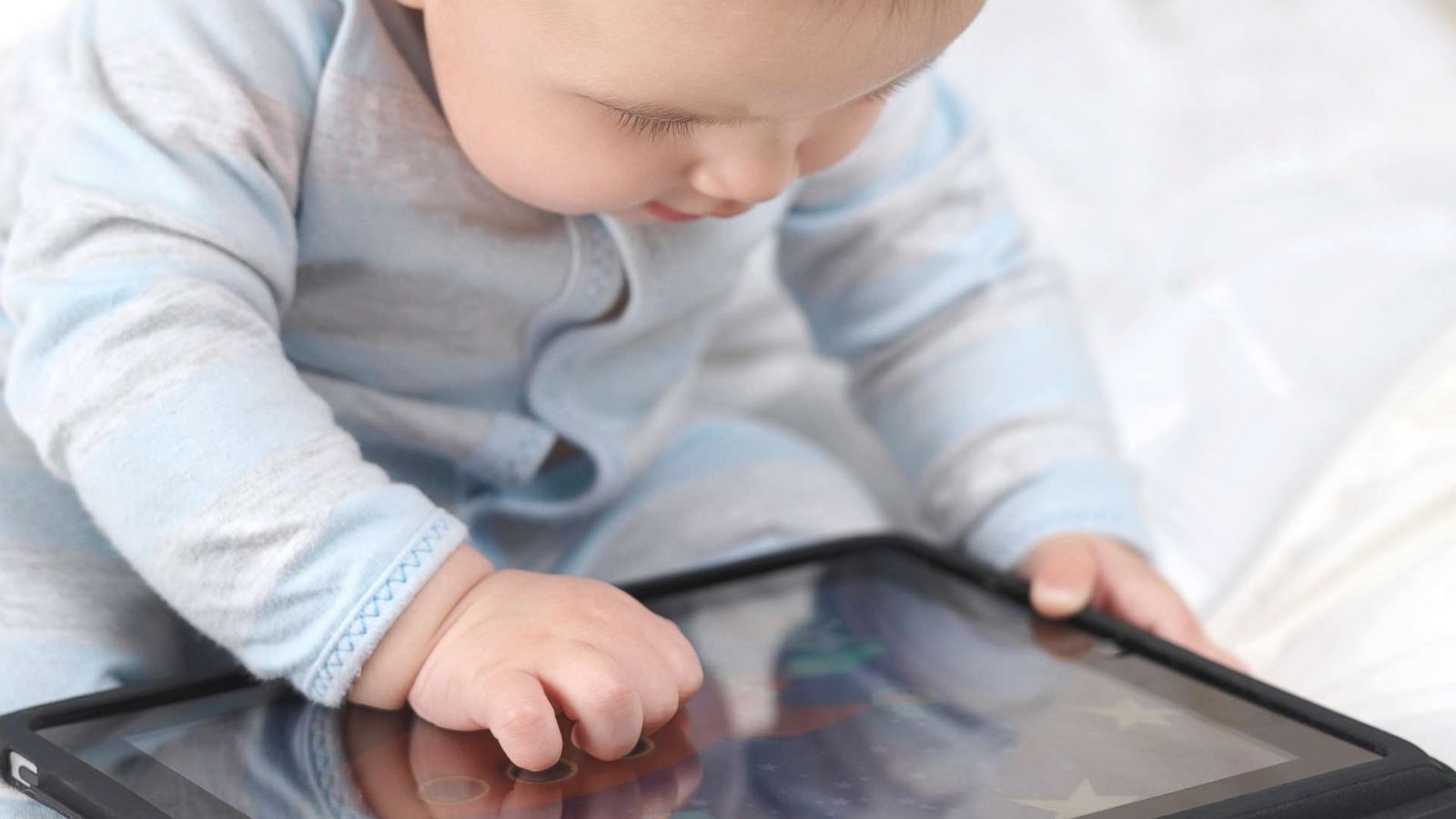 PHOTO: A toddler plays with a tablet in this undated stock photo.