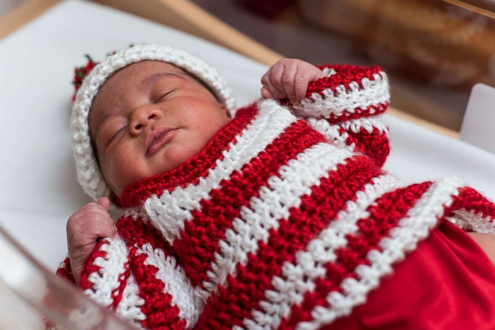 PHOTO: A newborn baby at UPMC Magee-Womens Hospital dressed in a striped ugly Christmas sweater. 
