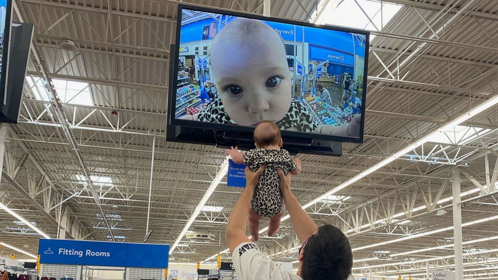 PHOTO: Mom Ivy Janzen captured the moment when her husband Nick Janzen lifted their 5-month-old, Kira, up to the television monitor in the Wichita, Kansas-based Walmart. The image of Kira was tweeted by on Oct. 15 and garnered viral attention.