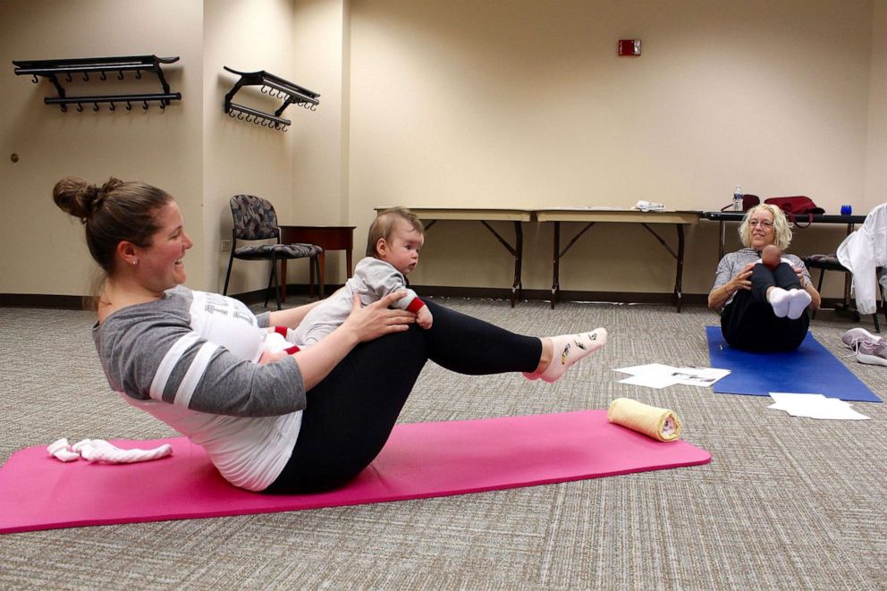 PHOTO: Patti Ideran, right, demonstrates a baby yoga pose for Amy Casoglos and her daughter Mia.