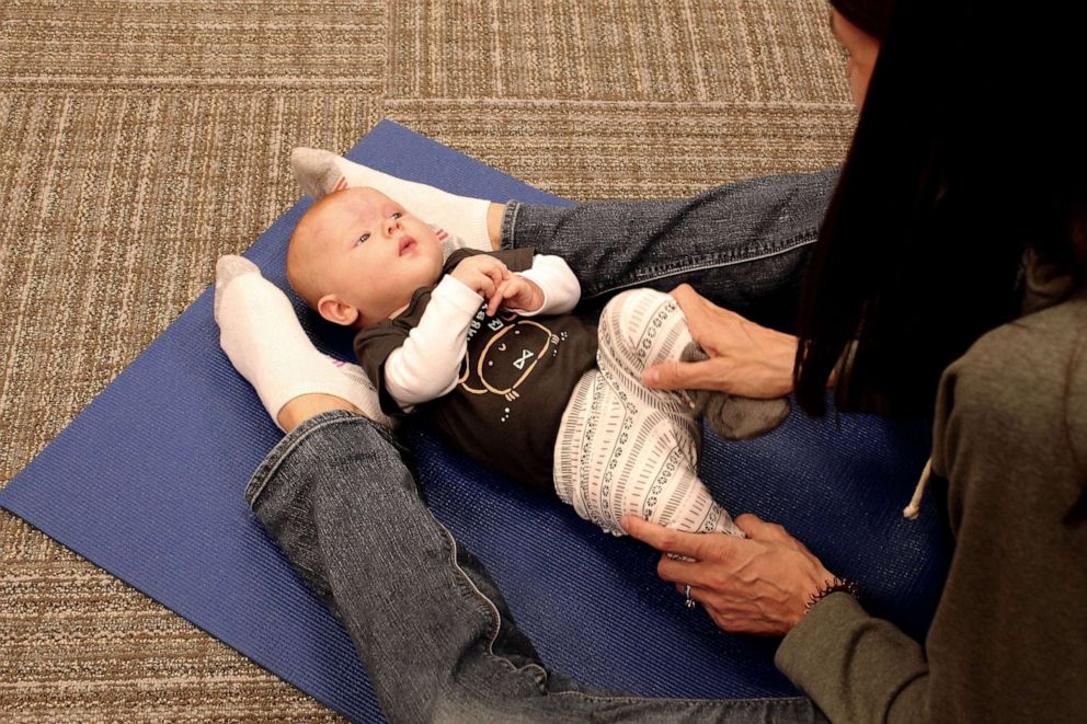 PHOTO: Susan Korver does yoga with her daughter Gracelyn in a baby yoga class.