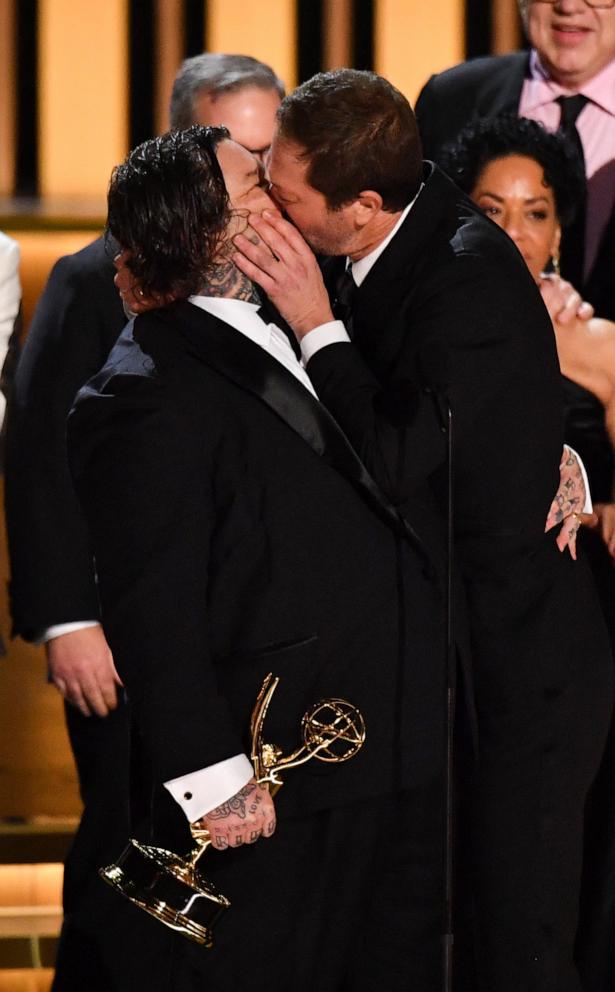 PHOTO: Actor Ebon Moss-Bachrach (R) kisses Canadian chef and actor Matty Matheson as the cast of "The Bear" accept the award for Outstanding Comedy Series during the 75th Emmy Awards at the Peacock Theatre at L.A. Live in Los Angeles on Jan. 15, 2024.