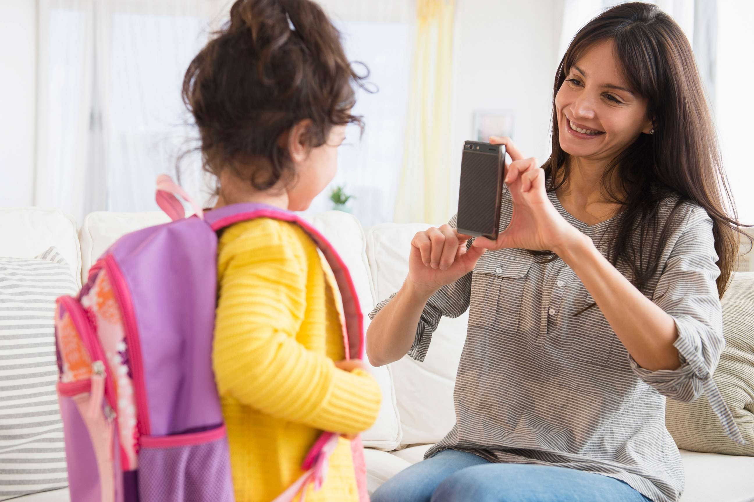 PHOTO: A mother takes a picture of her daughter while she gets ready for school in a stock image.